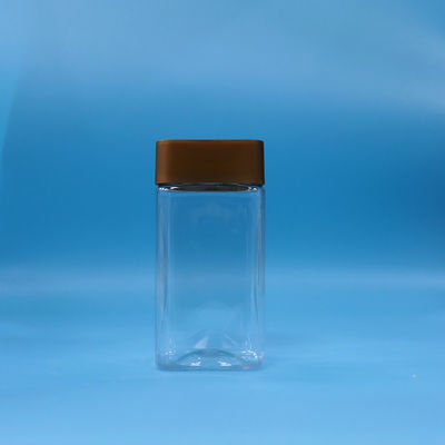 Voedingsmiddelenkwaliteit rechthoekig plastic honingpot met bruine dop en doorzichtig lichaam in PET-materiaal